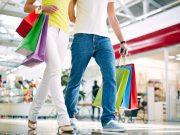 Legs of young couple going in the mall