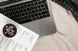 white-printer-paper-on-macbook-pro