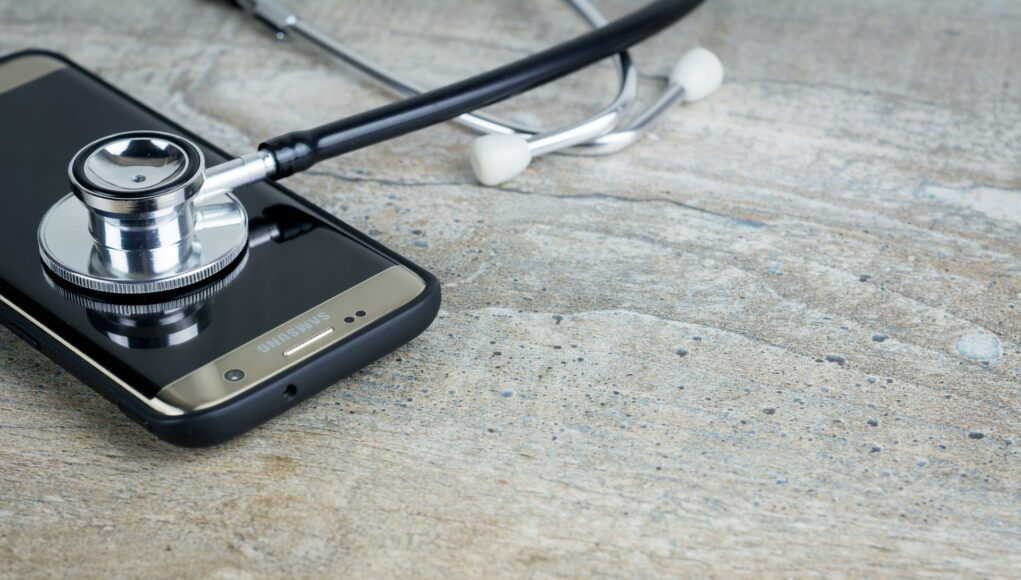 a-phone-with-a-stethoscope-on-top-of-it a-phone-with-a-stethoscope-on-top-of-it