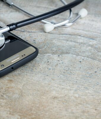 Why Are Health Apps So Costly to Build? a-phone-with-a-stethoscope-on-top-of-it